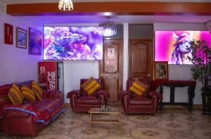 a living room with two couches and a large screen at Mirador All Sur Cusco in Cusco