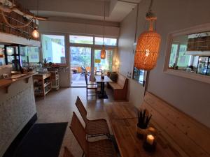 a living room with a table and chairs and a kitchen at Max Hostel in Bonn