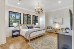 a bedroom with a bed and a chandelier at CM3008: 3008 Cameron Blvd. in Isle of Palms +67 photos