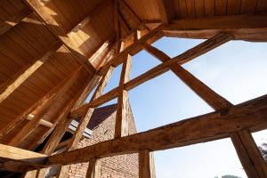 a view from the inside of a wooden building with windows at The incredible Alsatian house of the 21st century in Hangenbieten +4 photos