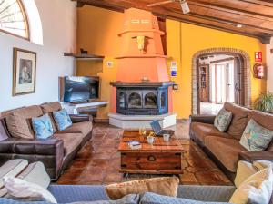 a living room with a couch and a fireplace at Holiday Home El Comendador by Interhome in Acebuchal