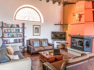 a living room with two couches and a fireplace at Holiday Home El Comendador by Interhome in Acebuchal