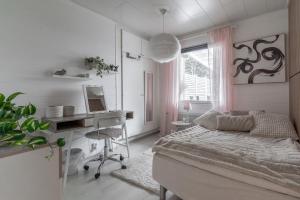 a bedroom with a bed and a desk and a computer at Rovaniemi Spacious Lapland Vacation Home with Private Sauna & Lappish Fire Hut in Rovaniemi