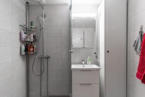 a bathroom with a shower and a sink at Rovaniemi Spacious Lapland Vacation Home with Private Sauna & Lappish Fire Hut in Rovaniemi +25 photos