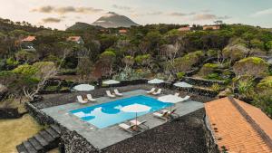 an aerial view of a resort pool with a mountain in the background at Pocinhobay in Madalena