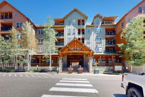 a large apartment building in a parking lot at Keystone Condo 8380 in Keystone