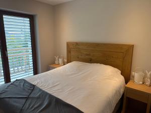 a bedroom with a white bed and a window at Haus Schlatti in Altenmarkt im Pongau +64 photos