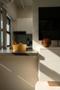 a bowl of food on a counter in a kitchen at Atrium Apartments - Cocoa Villa in Grand Anse