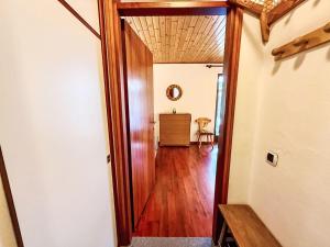 a hallway with a wooden door in a room at Apartment Marmolada-12 by Interhome in Alba di Canazei