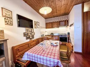 a kitchen with a table with a table cloth on it at Apartment Marmolada-12 by Interhome in Alba di Canazei +33 photos