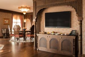 a living room with a table and a television on a wall at AJWA Sultanahmet - Preferred Hotels LVX Collection in Istanbul