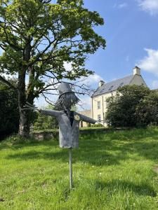 a statue of a person in the grass at The Farmhouse at Solsgirth Home Farm in Dollar