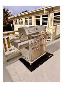 a grill sitting on a porch next to a house at Newly Renovated Brand New, Pristine 3Bedroom House in Christiansted +80 photos