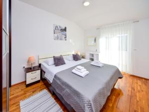 a bedroom with a large bed with towels on it at Holiday Home Marija by Interhome in Primorski Dolac