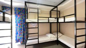 three bunk beds in a room with a window at O Plácido Arte Hostel in Belém