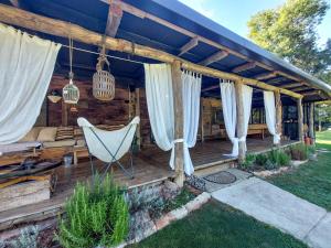 a deck with a couch and a hammock at Holiday Home Utinja by Interhome in Skakavac +42 photos