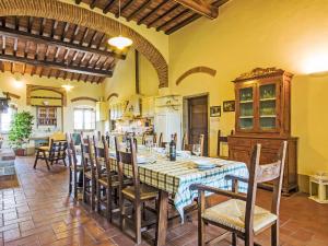 a kitchen and dining room with a table and chairs at Villa La Salciaia-1 by Interhome in Marciano
