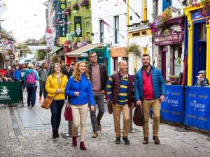 a group of people walking down a street at Holiday Home Galway Bay - TR4Lodge by Interhome in Doughiska