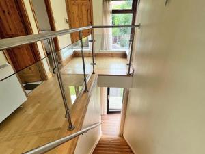 a staircase in a house with a glass railing at Holiday Home Castle Quay - TR4 HH No 14 by Interhome in Barrel Cross Roads