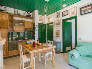 a kitchen and dining room with a table and a couch at Apartment Appartamento Residence Henderson by Interhome in Cinquale +28 photos