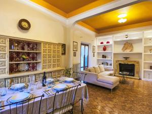 a dining room with a table and a couch at Holiday Home La Pausa by Interhome in Ponteginori