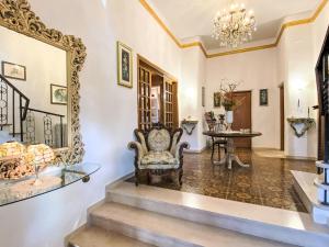 a living room with a chair and a mirror at Holiday Home La Pausa by Interhome in Ponteginori
