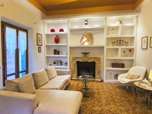 a living room with a couch and a fireplace at Holiday Home La Pausa by Interhome in Ponteginori +62 photos