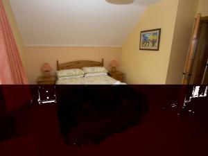 a bedroom with a bed with two pillows on it at Holiday Home Willow Grove HC No- 4 by Interhome in Mervyn +13 photos