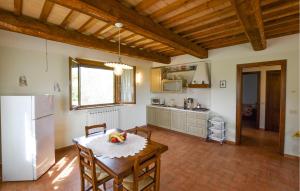 a kitchen with a table and a white refrigerator at Seranna 4 in Papiano
