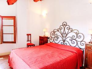 a bedroom with a red bed with a red blanket at Apartment Cielo Terra by Interhome in Gambassi Terme