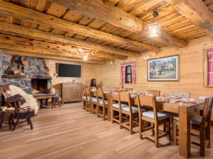 a dining room with a large table and a fireplace at Holiday Home Relax Lika by Interhome in Tomingaj