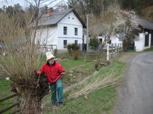 a man standing in the grass with a stick at Petrovický mlýn in Kasanice