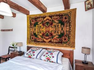 a tapestry hangs above a bed in a bedroom at Apartment Kalina by Interhome in Stoczek