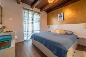a bedroom with a bed and a large window at Stone villa Jurenda with pool in Debeljak +60 photos