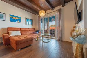 a living room with a couch and a table at Stone villa Jurenda with pool in Debeljak