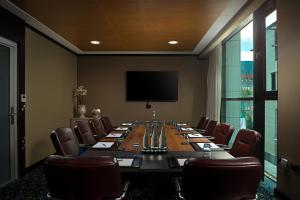 a conference room with a long table and chairs at The Savoy Hotel in Limerick +57 photos