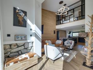 a living room with a stone fireplace at Chalet rénové 10 personnes à Tignes, sauna inclus - FR-1-641-121 in Tignes