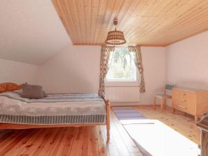 a bedroom with a bed and a window at Holiday Home Mörtefors by Interhome in Virserum