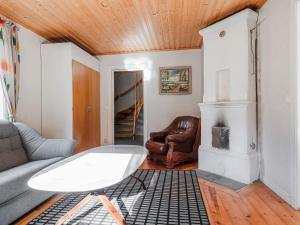 a living room with a couch and a table at Holiday Home Mörtefors by Interhome in Virserum