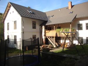 a house with a basketball hoop in front of a house at Petrovický mlýn in Kasanice