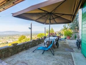 a patio with a table and chairs and an umbrella at Holiday Home La Sosta di Fano by Interhome in Reggello