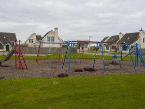 an empty playground in a park with houses at Holiday Home Willow Grove HC No- 3 by Interhome in Mervyn