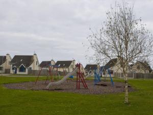 a playground with a slide in a park at Holiday Home Willow Grove HC No- 3 by Interhome in Mervyn +15 photos