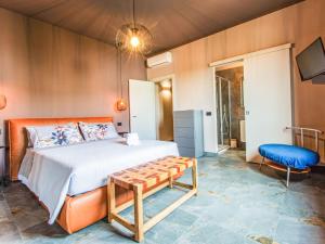 een slaapkamer met een bed, een stoel en een tv bij Apartment Michelle by Interhome in San Romano