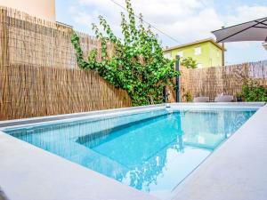 een zwembad voor een hek bij Apartment Michelle by Interhome in San Romano