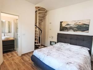 a bedroom with a large bed and a sink at Villa Graziella by Interhome in Malcesine