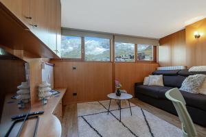 a living room with a couch and a table at Bardoney Ski Lodge in Breuil-Cervinia