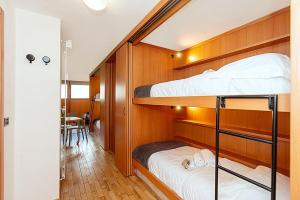 two bunk beds in a room with a table at Bardoney Ski Lodge in Breuil-Cervinia