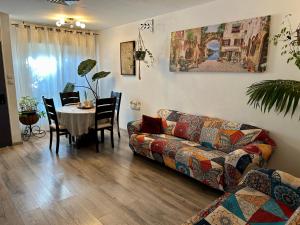 a living room with a couch and a table at Limor-resident in Qasrîne