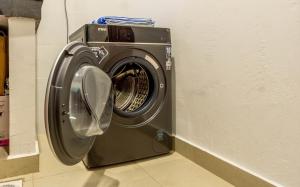 a washing machine is sitting in a room at Elna's Baobab Waves - 2BR and 3BR Beachfront Nyali in Mombasa